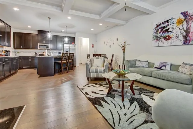 a living room with furniture kitchen view and a counter