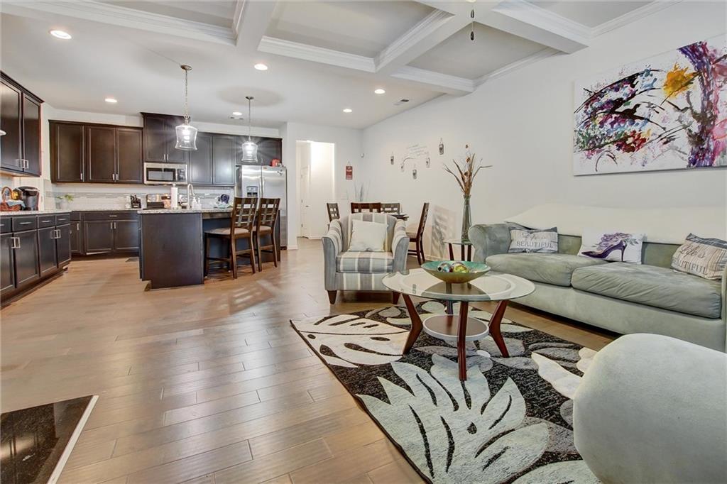 7687 Cabrini Place Fairburn, GA 30213 - Photo 3 of 29 a living room with furniture kitchen view and a counter