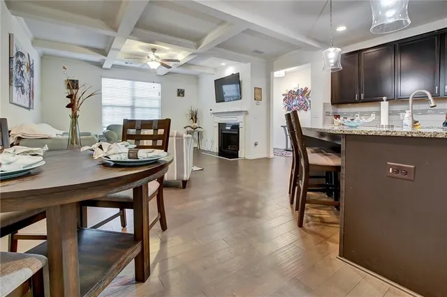 a kitchen with a table chairs microwave and cabinets