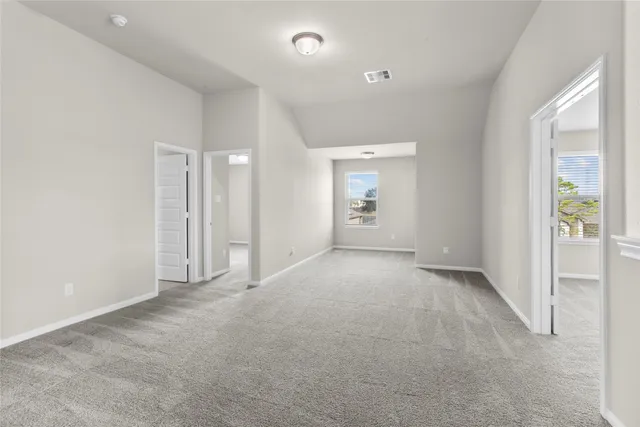 an empty room with a empty space and windows