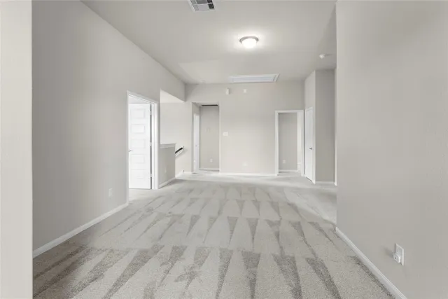 a view of an empty room and window and wooden floor