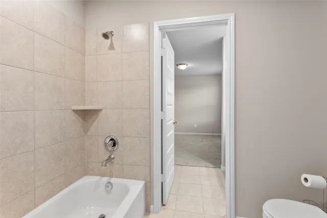 a bathroom with a tub shower and sink