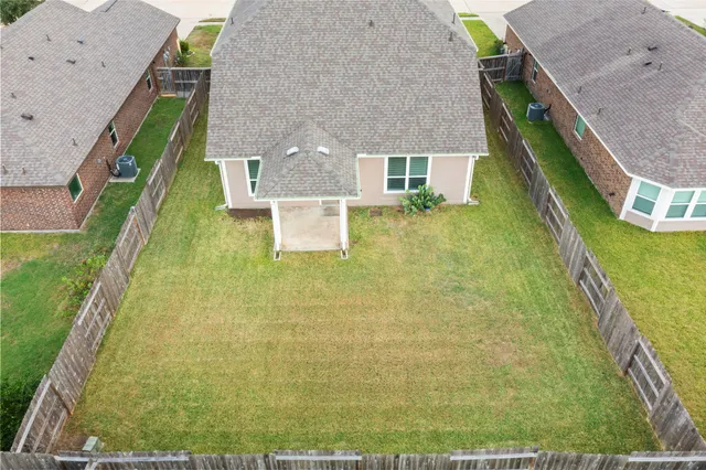 a aerial view of a house with a yard