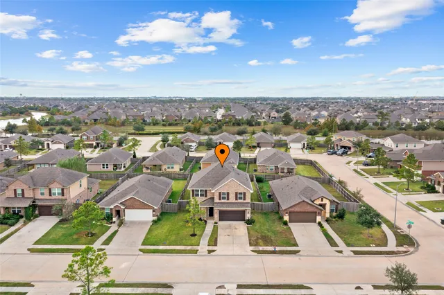 an aerial view of residential houses with outdoor space