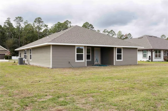 a view of a house with a yard and garage