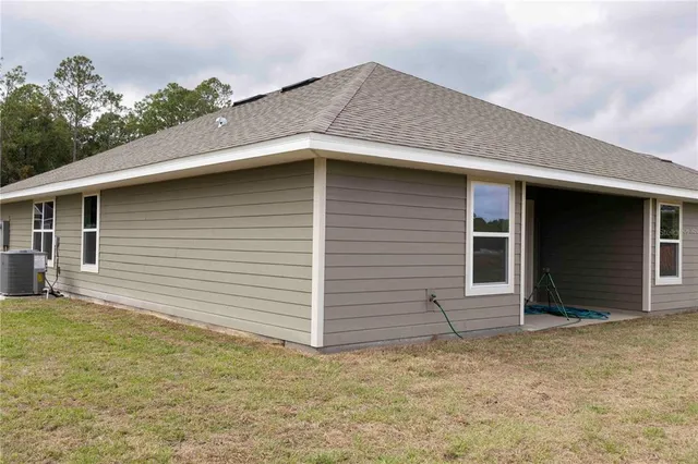 a view of house with backyard and garden
