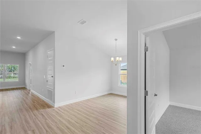 a view of a room with wooden floor and a window