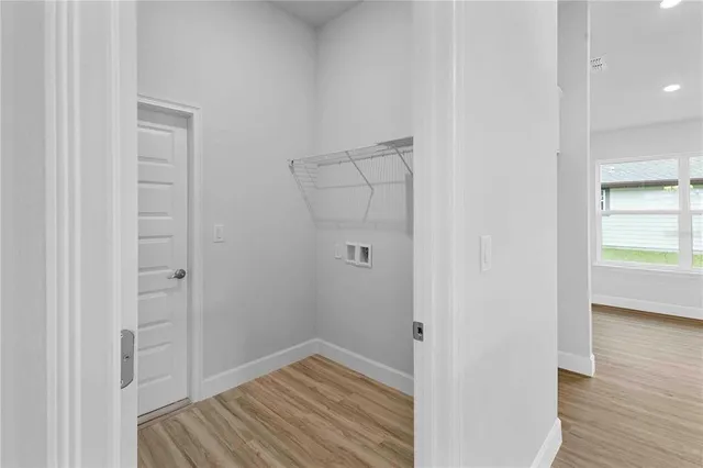 a kitchen with stainless steel appliances granite countertop a stove top oven a sink and white cabinets