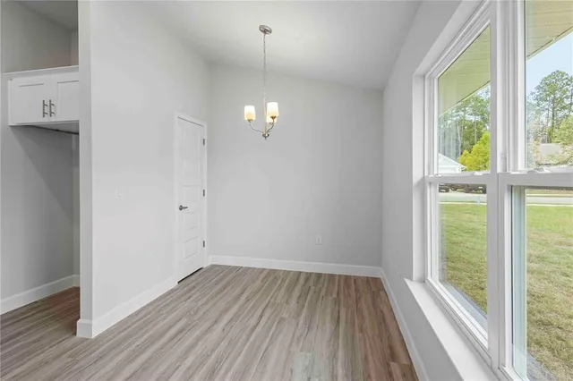 a kitchen with granite countertop white cabinets and a sink