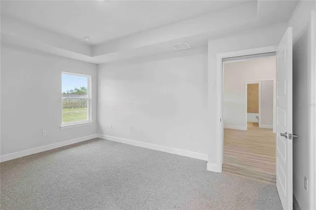 a bathroom with a granite countertop toilet a sink and a mirror