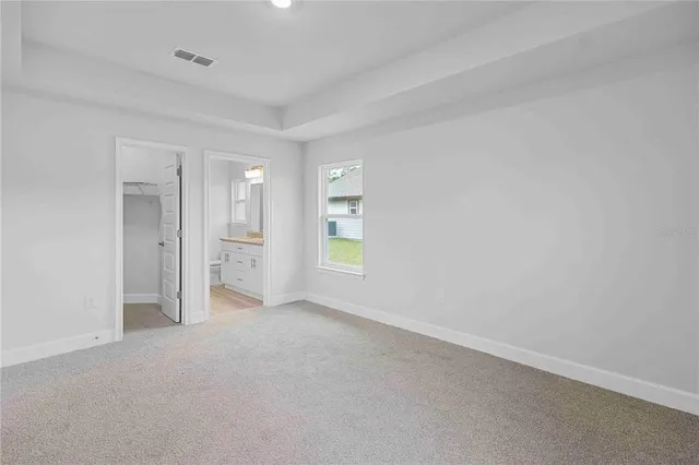 a view of wooden floor and windows in a room