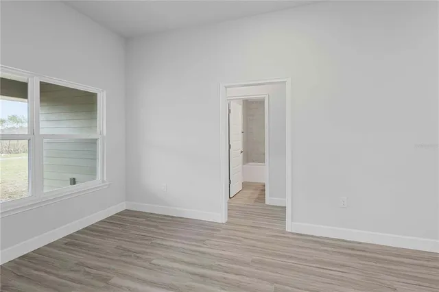 an empty room with windows and closet