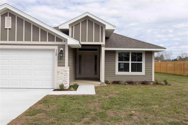 a front view of a house with garden