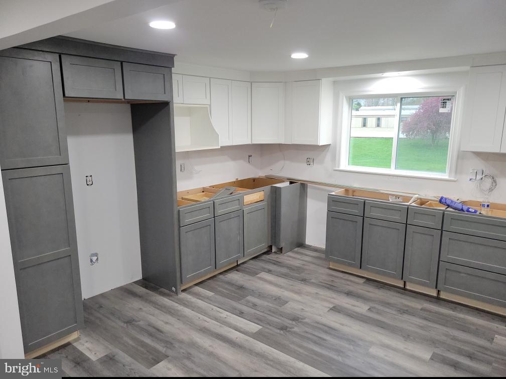 a kitchen with a sink window and cabinets