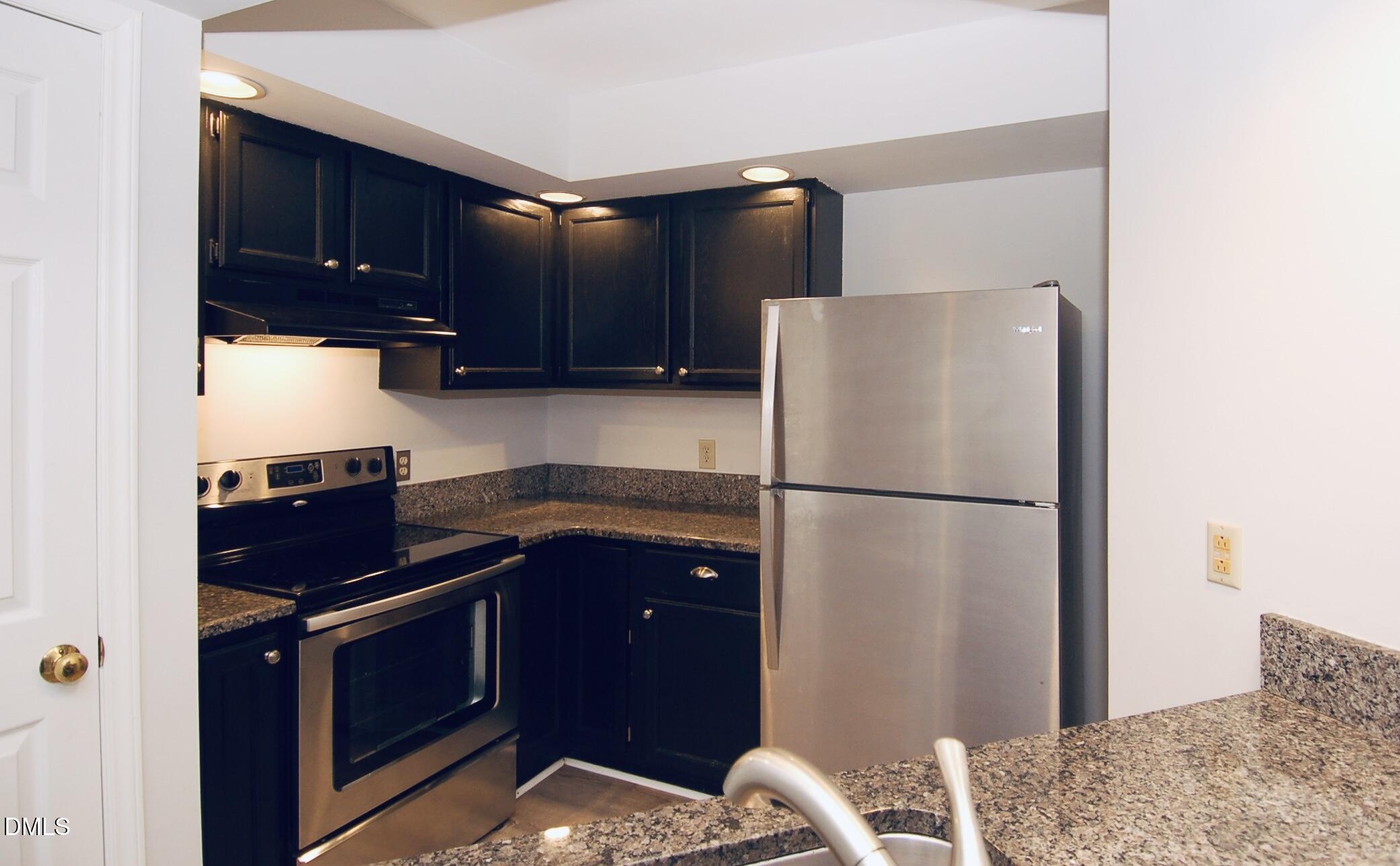 1450 Barton Pl Drive Raleigh, NC 27608 - Photo 3 of 11 a kitchen with a refrigerator and a sink