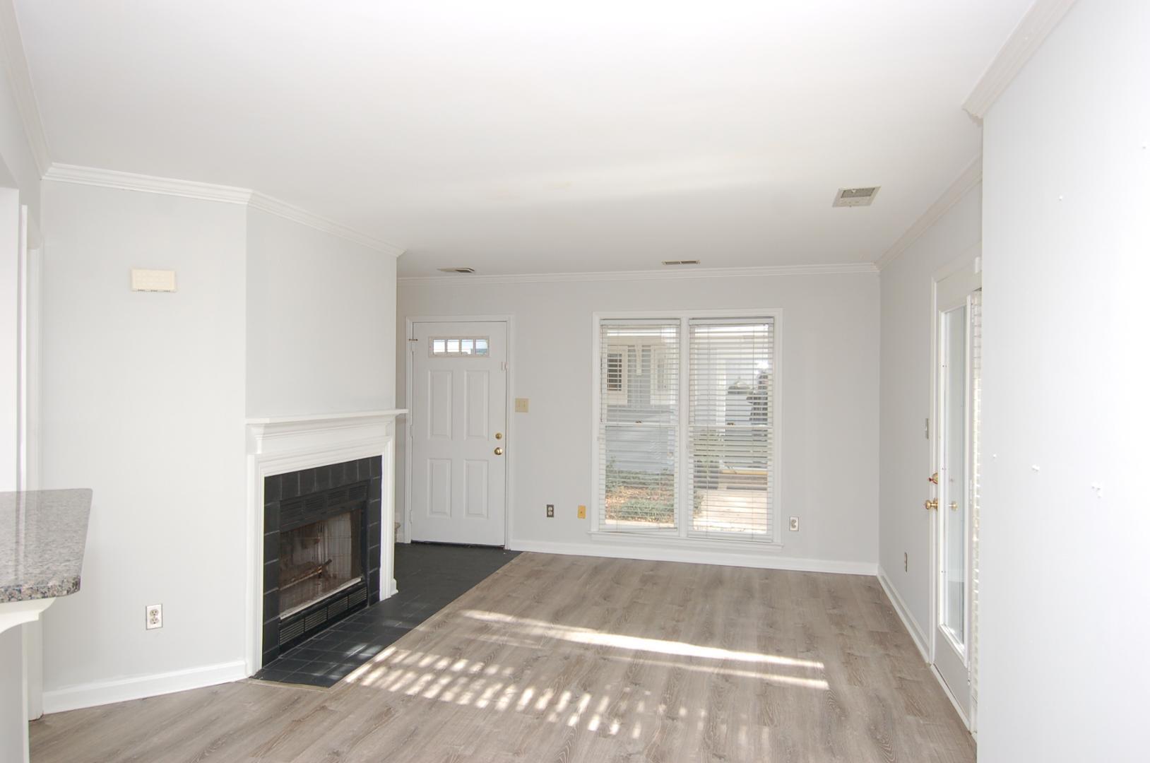 1450 Barton Pl Drive Raleigh, NC 27608 - Photo 4 of 11 a view of an empty room with a fireplace and a window