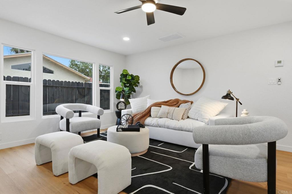 1333 Helix Street Spring Valley, CA 91977 - Photo 20 of 45 a living room with furniture a chandelier and a large window