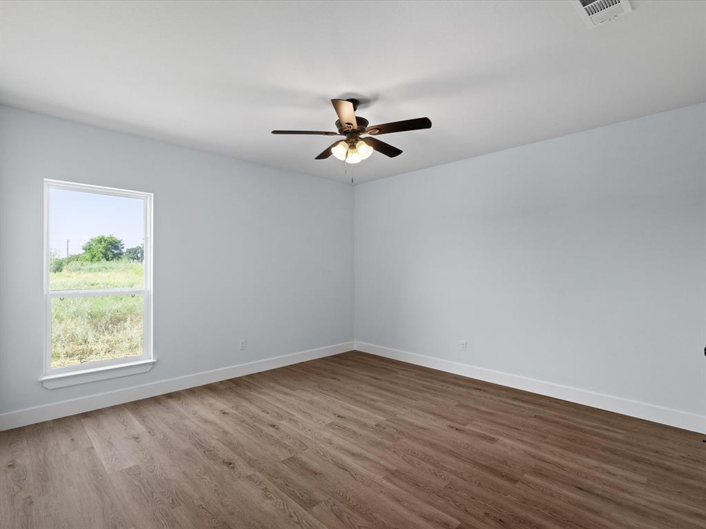 1013 Magnolia Court Springtown, TX 76082 - Photo 21 of 33 wooden floor in an empty room with a window