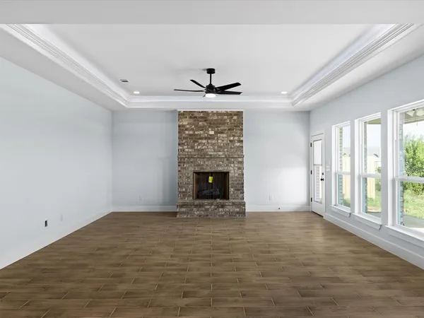 wooden floor in an empty room with a fireplace
