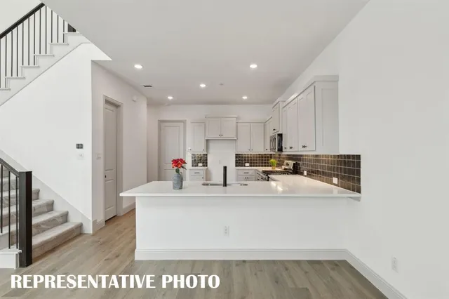 a view of kitchen with center island and stainless steel appliances