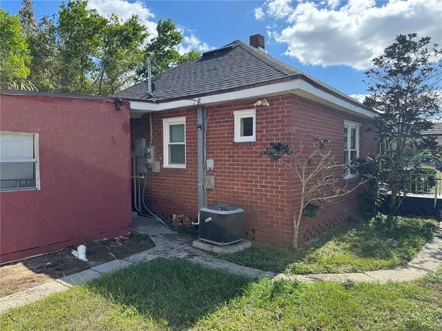 a view of backyard of house with green space