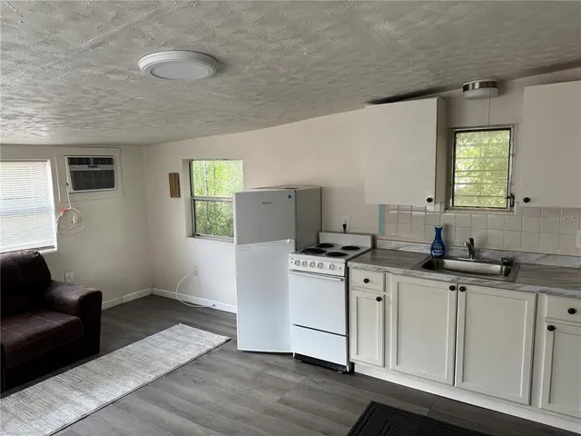 a kitchen with a sink cabinets and window