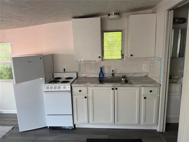 a room with cabinets a washer and dryer