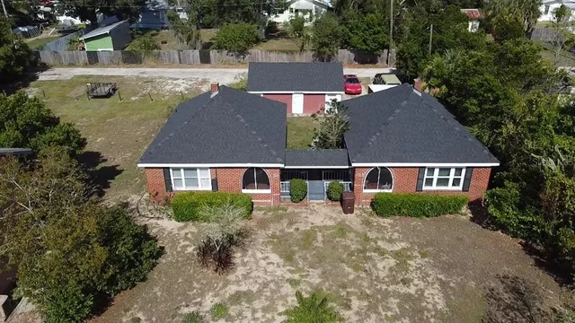 an aerial view of house with yard swimming pool and outdoor seating