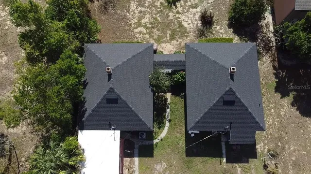 an aerial view of houses with trees