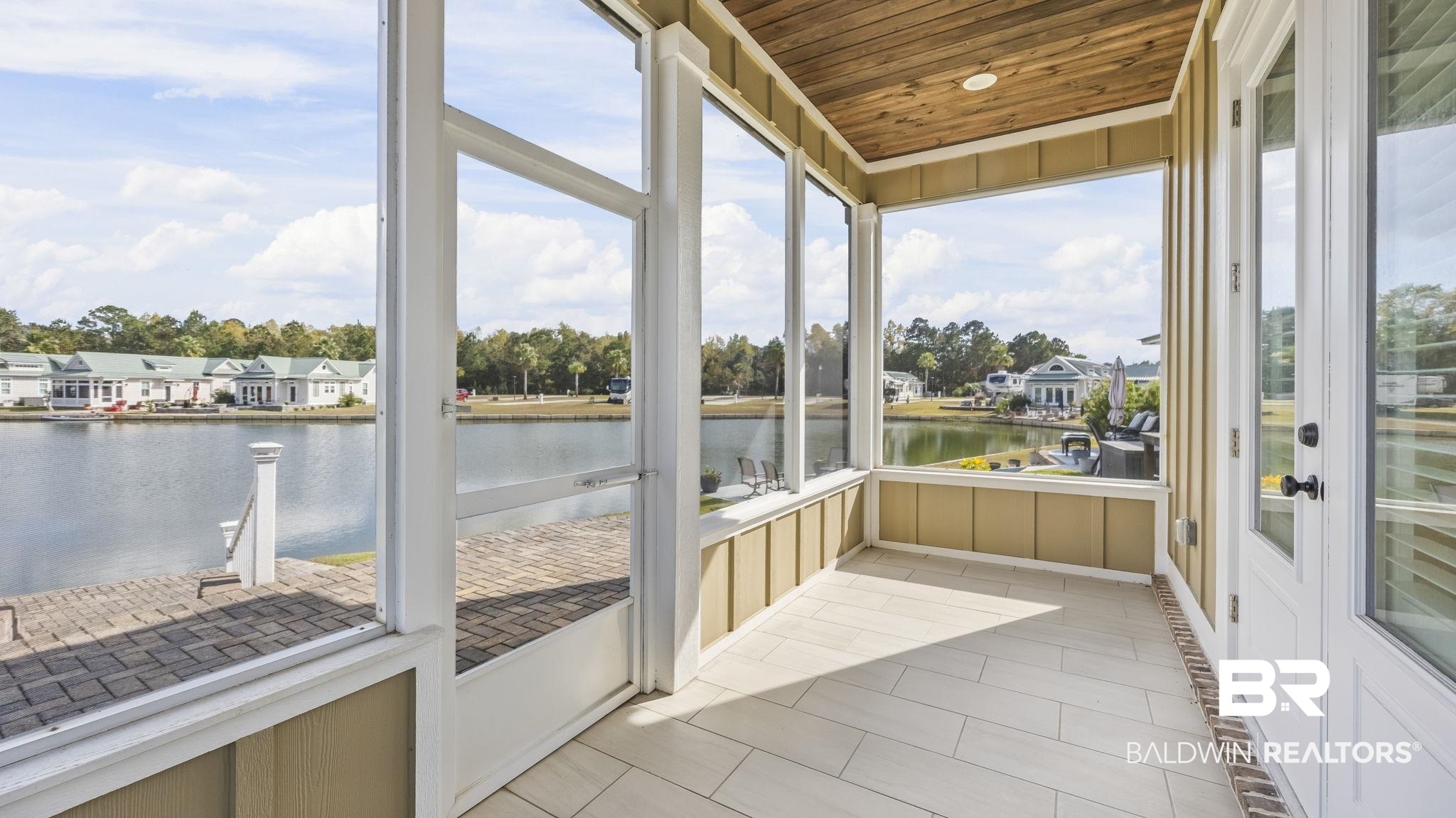 12004 Raptor Court Elberta, AL 36530 - Photo 5 of 57 Unfurnished sunroom with a water view, wood ceiling, a residential view, and tile patterned flooring