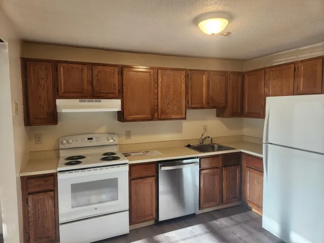 a kitchen with a sink stove and refrigerator