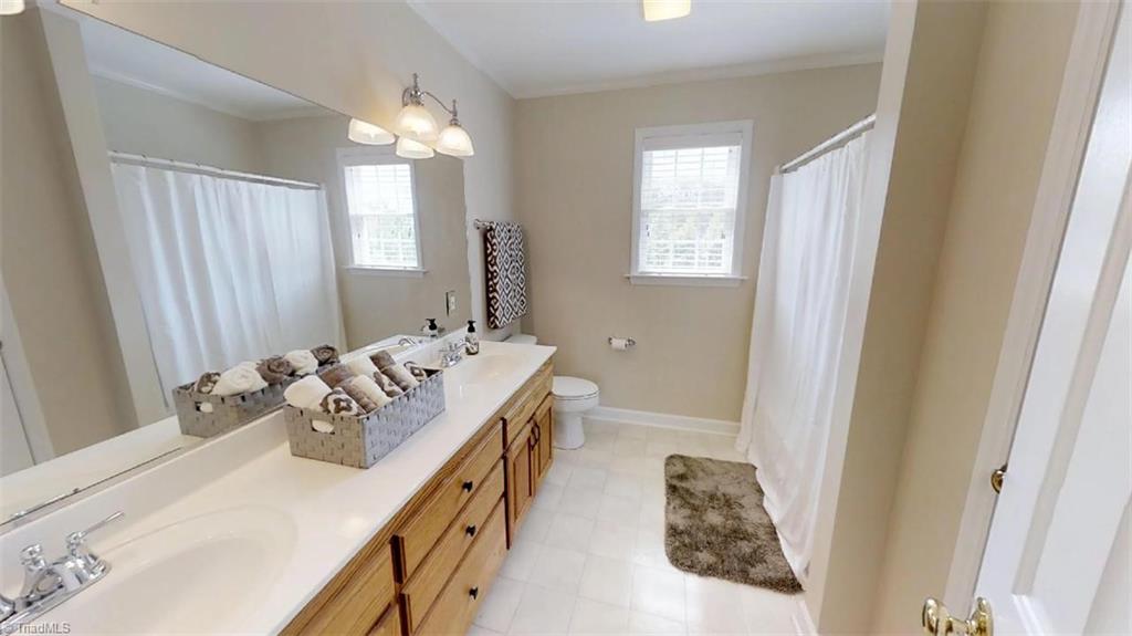 571 Carson Road Pilot Mountain, NC 27041 - Photo 28 of 30 Upper level full bath with double vanity, tub/shower combo & linen closet.