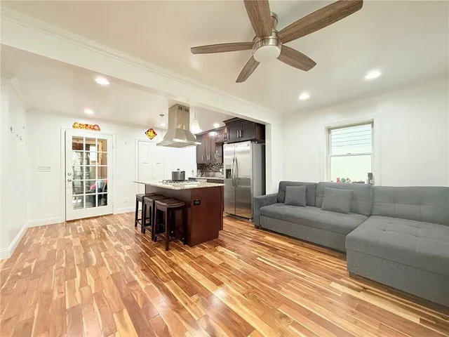 a kitchen with a sink cabinets and wooden floor