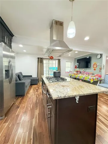 a kitchen with kitchen island a counter top space a sink appliances and cabinets