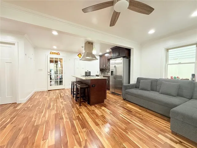 a living room with kitchen island furniture and a wooden floor