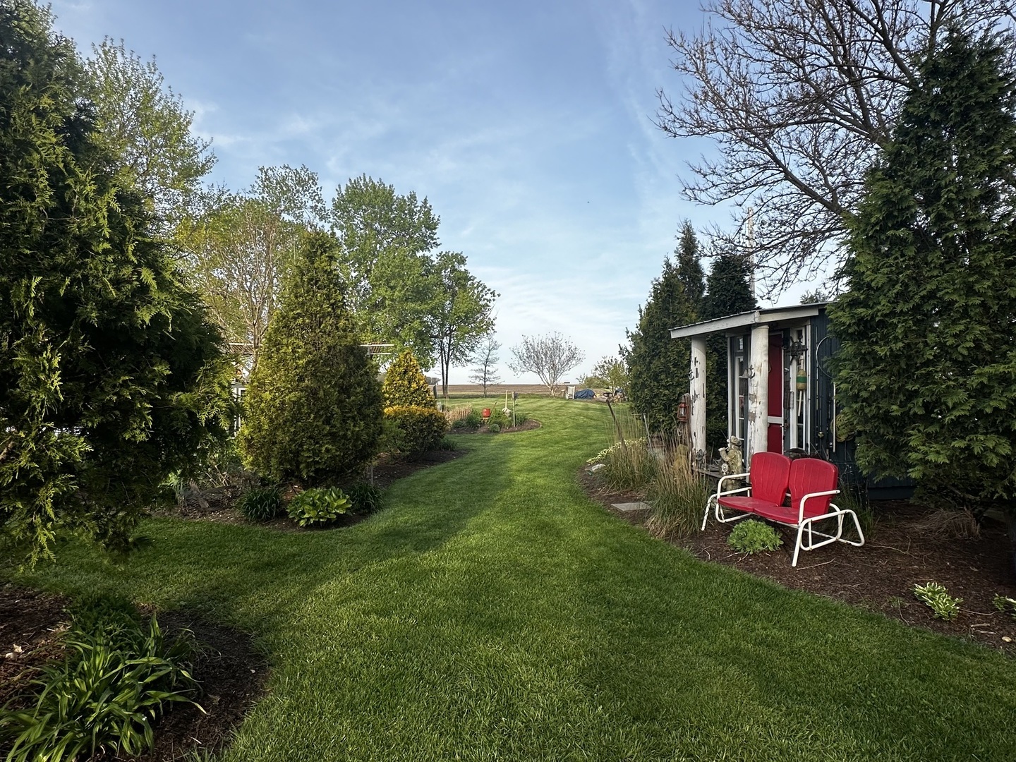 860 East 1100 Road Champaign, IL 61822 - Photo 13 of 60 a backyard of a house with table and chairs