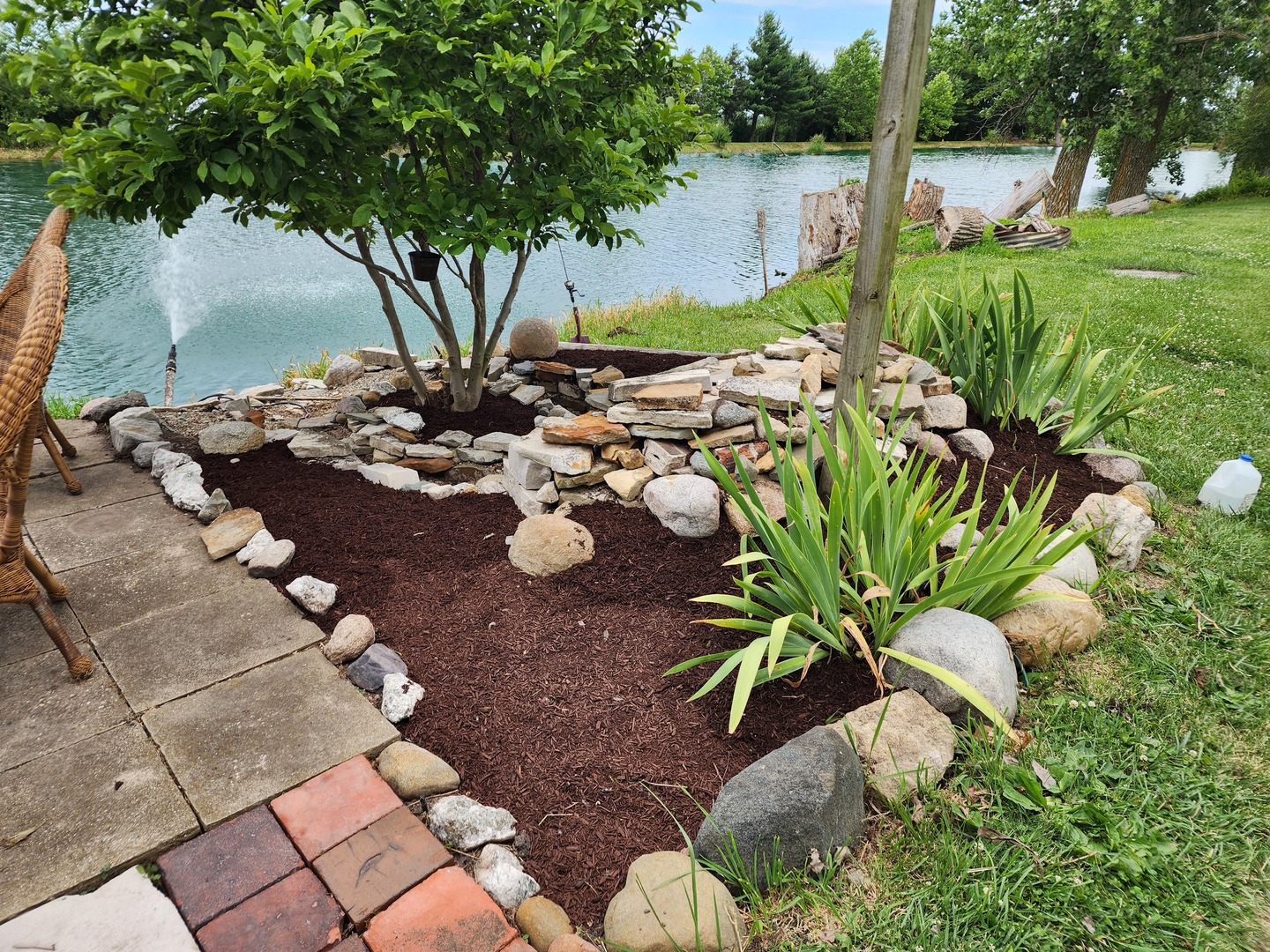 860 East 1100 Road Champaign, IL 61822 - Photo 6 of 60 a view of a garden with lawn chairs under an umbrella