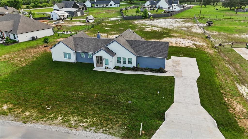 an aerial view of a house with a garden and lake view