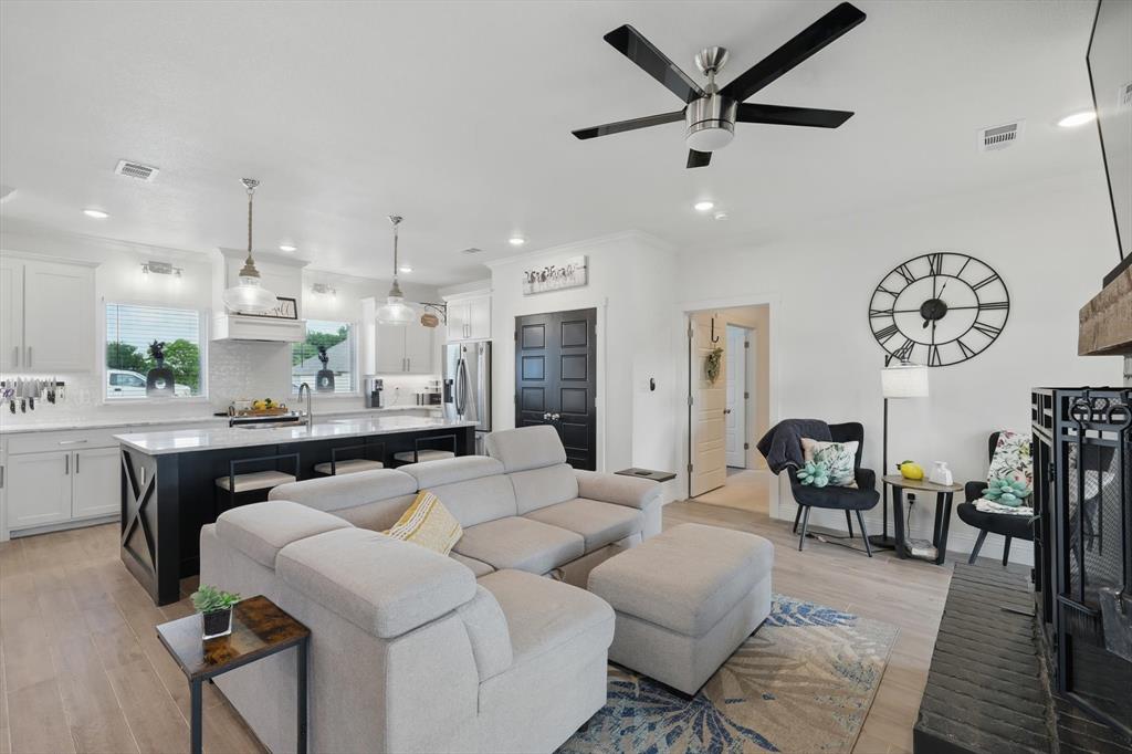 a living room with furniture a window and kitchen view