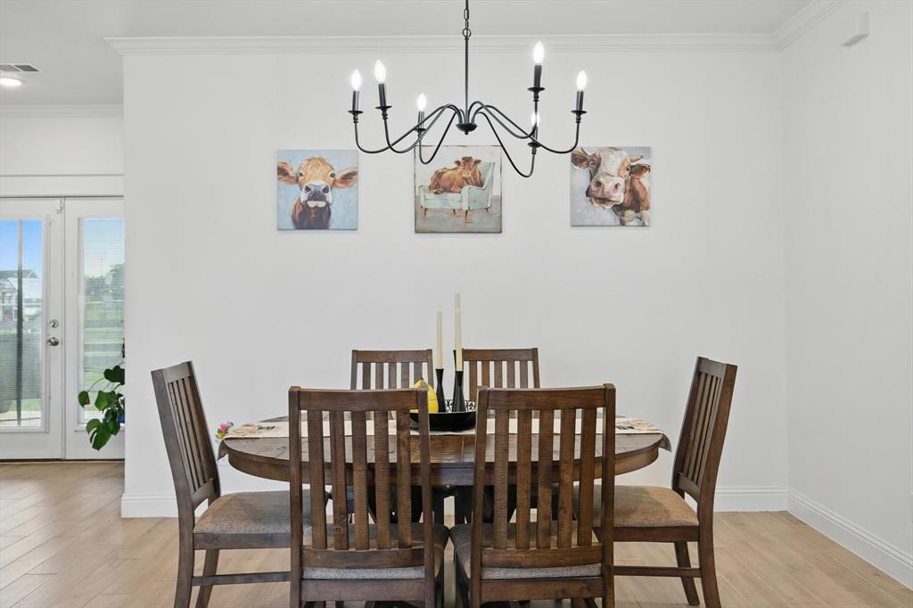 121 Bluegrass Trail Springtown, TX 76082 - Photo 5 of 39 a view of a dining room with furniture wooden floor and chandelier