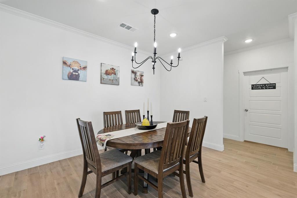 121 Bluegrass Trail Springtown, TX 76082 - Photo 6 of 39 a view of a dining room with furniture and wooden floor