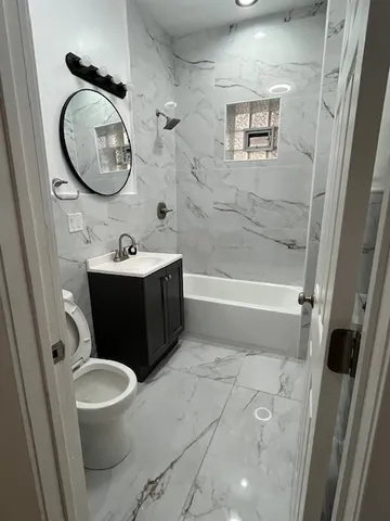 a bathroom with a toilet a sink and a mirror
