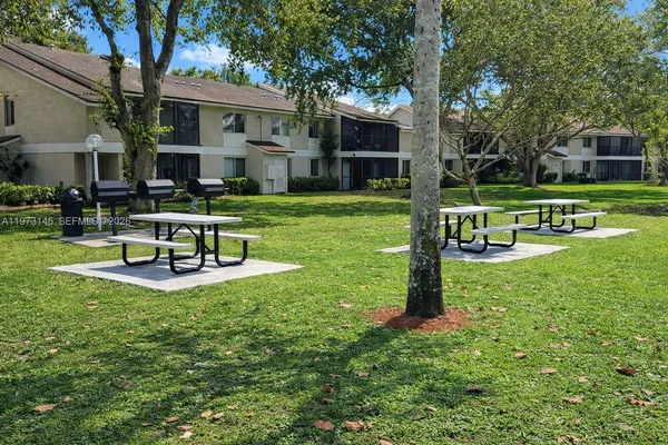 a view of a house with backyard porch and sitting area
