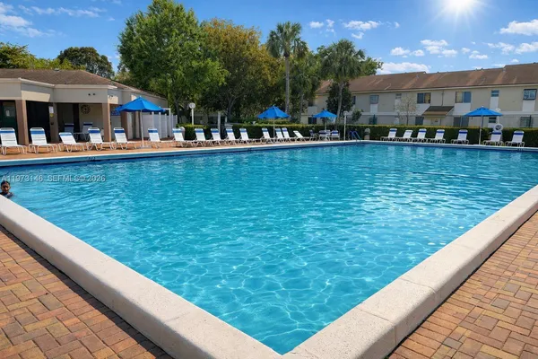 a view of swimming pool with outdoor seating and city view
