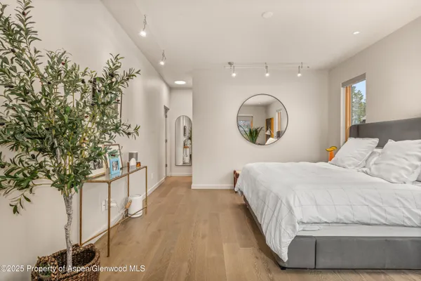 a bathroom with a granite countertop sink toilet a mirror and shower