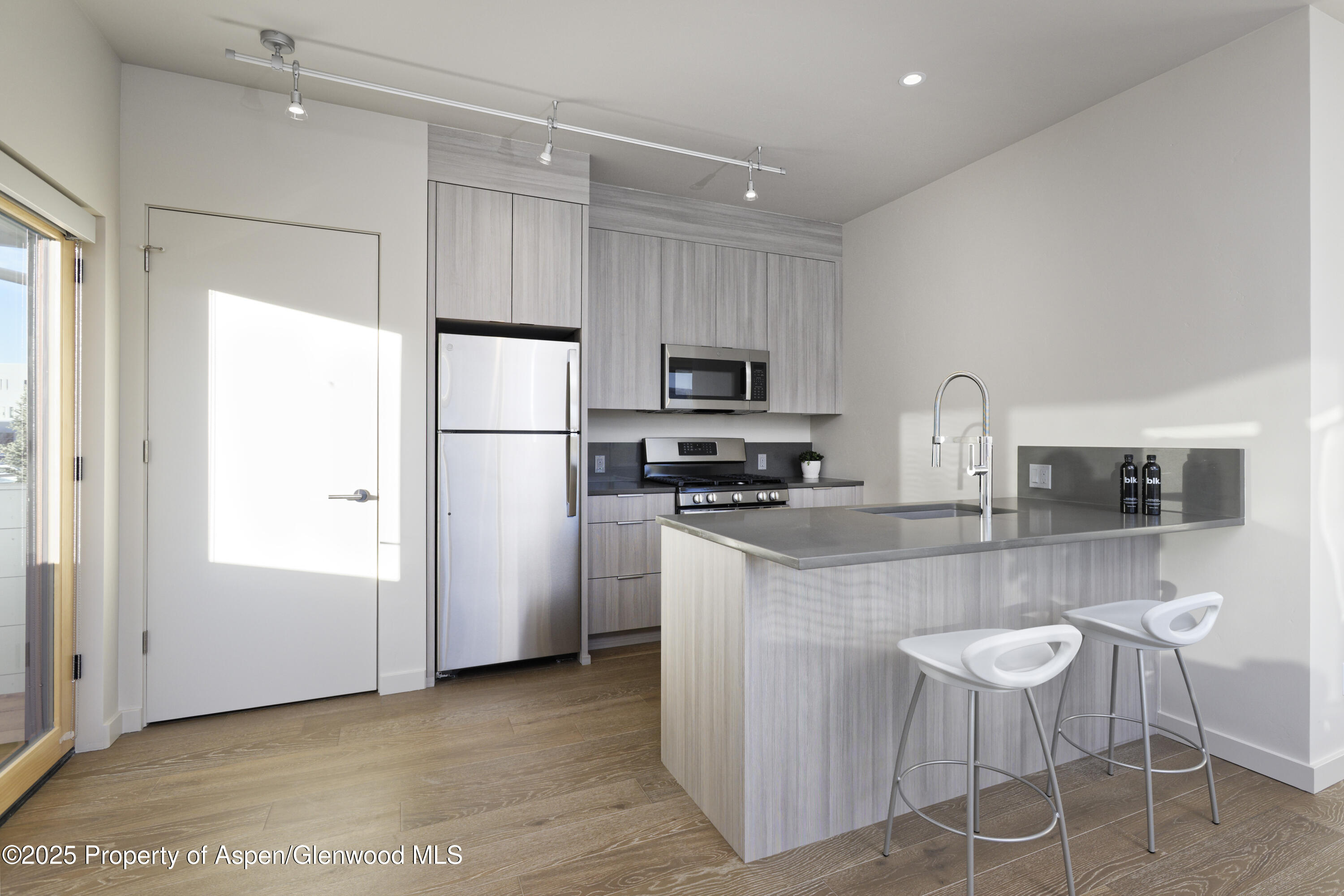 113 Valley Court Basalt, CO 81621 - Photo 33 of 34 a kitchen with stainless steel appliances granite countertop a refrigerator a stove a sink a dining table and chairs