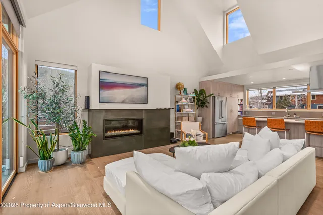 a living room with a table chairs and a flat screen tv