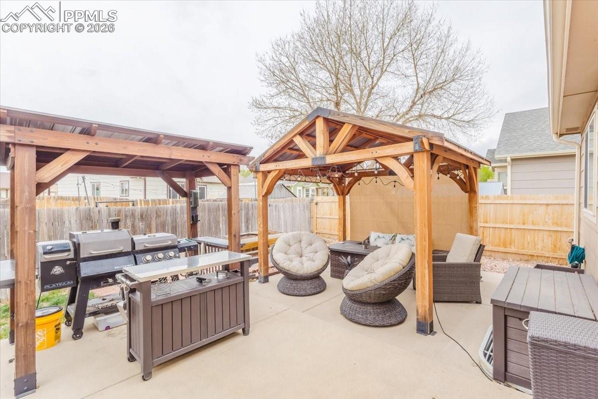 4780 Brant Road Colorado Springs, CO 80911 - Photo 42 of 49 Fenced backyard with a gazebo, an outdoor living space.