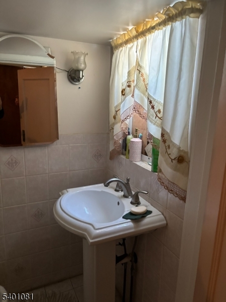 306 East 34th Street Paterson, NJ 07504 - Photo 12 of 12 a bathroom with a sink and a mirror