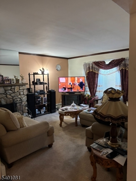 306 East 34th Street Paterson, NJ 07504 - Photo 5 of 12 a living room with furniture and a flat screen tv